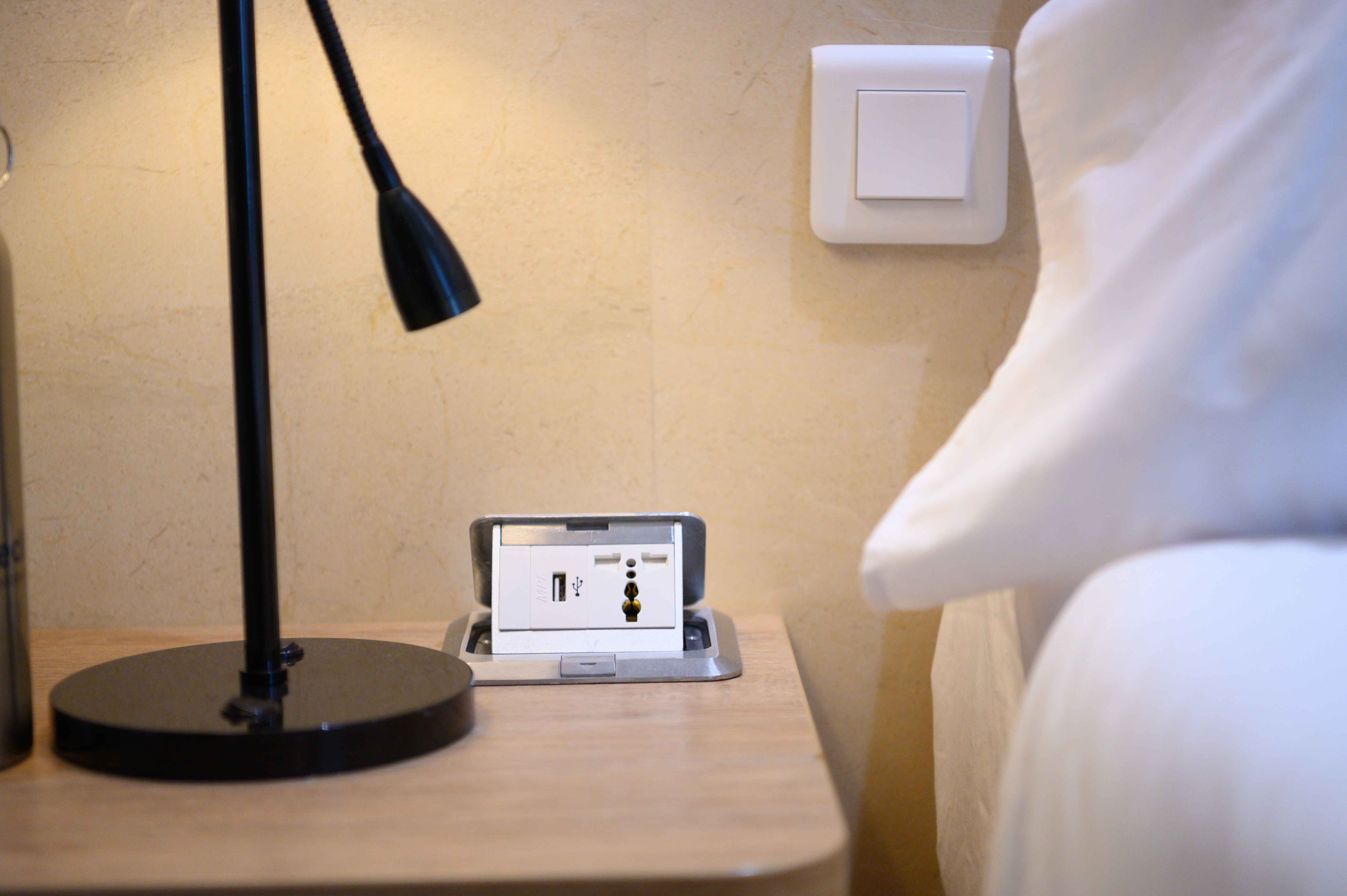 Coral Expeditions - Coral Adventurer - Accommodation - Convinient pop up bedside USB charging ports, draws, bed side lamp & reding light..jpg